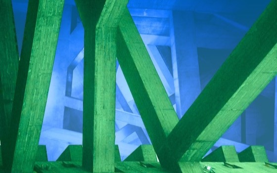 Green brutalist structure of unclear purpose atop more abstract brutalism, but blue, kind of hand-drawn